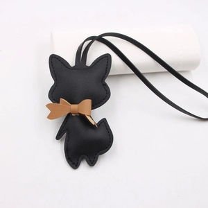 Detail of creative leather fox charm with neat stitching and a cute brown bowtie