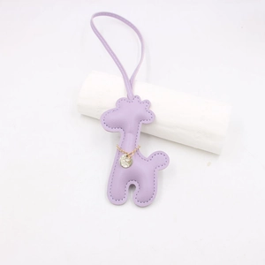 Detail of lavender leather giraffe keychain with gold chain and matching lanyard
