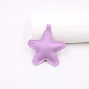 Close-up of a purple star-shaped leather pendant with precise stitching for DIY accessories