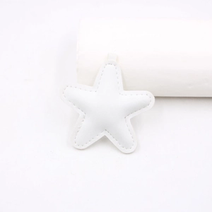 Detailed view of a white PU leather star pendant with fine stitching and a hanging loop