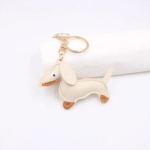 Exquisite cream leather dachshund dog keychain with litchi texture and gold hardware