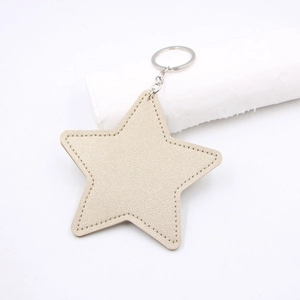 Flat golden star keychain made of premium faux leather with neat stitching and silver ring