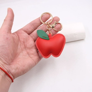 Creative red apple leather keychain with green leaf detail and golden metal lobster clasp