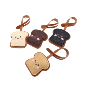 Cute toast shaped leather bag charms with smiling faces in four different colors