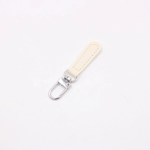 Close-up of cream leather zipper pull with silver rotating lobster clasp for DIY bags