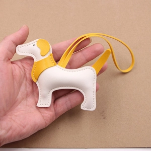 Ciondolo per borsa a forma di cane in pelle color crema e giallo con dettagli cuciti