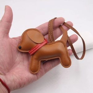 Creative brown leather puppy bag charm with red collar and long matching lanyard