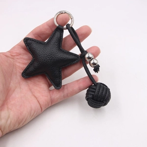 Black lychee leather star keychain with woven ball and silver spring clip for bags