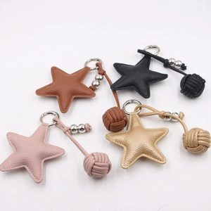 Star-shaped leather keychain set with woven ball details in four assorted colors
