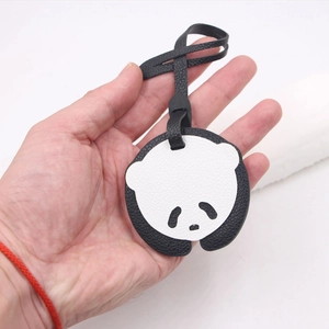 Cute panda leather bag charm with lychee texture and black lanyard on white background