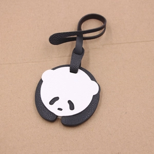 Cute panda leather bag charm with black lychee texture strap on beige background