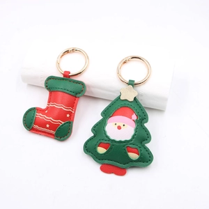 Christmas tree and Santa sock leather keychain with gold ring in a 45-degree view