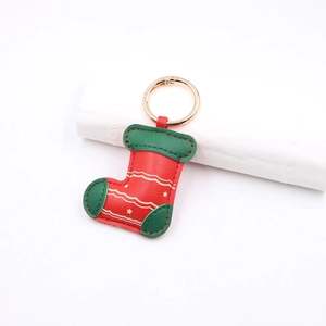 Christmas stocking leather keychain in red and green with golden metal ring detail