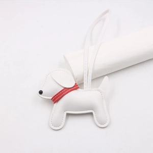 Detail of white leather dog charm with red collar and black bead nose detail