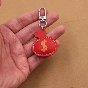 Red faux leather money bag keychain with dollar sign and silver metal carabiner
