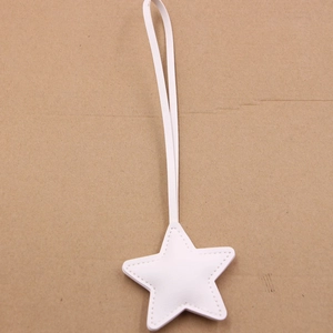 Detail of white star leather charm with fine stitching and long matching thin lanyard