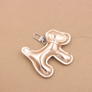 Détail macro du charm chien en cuir PU métallisé avec fermoir à ressort argenté