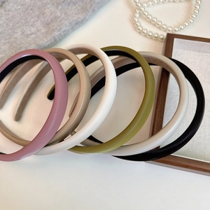 Detail view of multi-color matte sponge headbands including pink beige and olive green