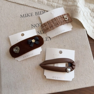 Three-piece brown French bow hair clip set with tweed and velvet textures for women