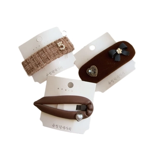 Brown French hair clip set with tweed and velvet textures plus pearls and bow accents