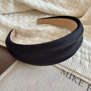 Elegant black satin padded headband for women with a minimalist luxury silk glossy finish