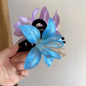 Elegant French lily flower hair claw clip with lifelike blue and purple fabric petals