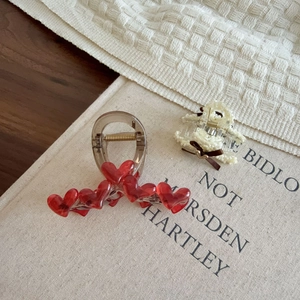 Large elegant heart hair claws with red charms and bow details for thick hair volume