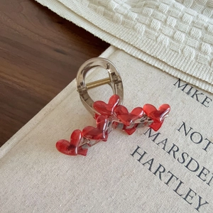 Elegant large heart hair claw clip with deep red resin hearts and gold metal spring