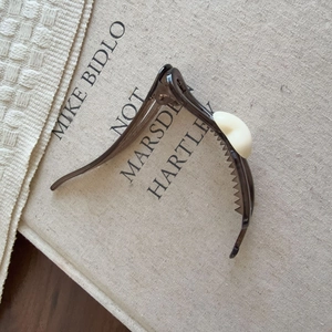 Eleganter Haarclip in Bananenform aus dunkelbraunem Harz mit cremeweißem Akzent