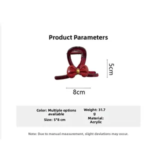 Detail view of red acrylic bow hair claw clip showing 8cm width and 5cm height dimensions