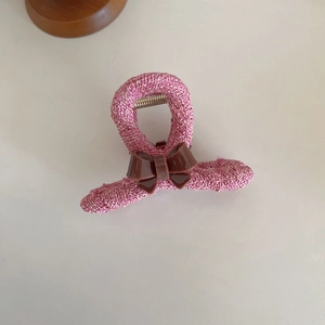 Pink woven fabric hair claw clip with a brown acrylic bow and durable metal spring