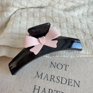 Elegant large black hair claw clip featuring a sweet pink ribbon bow for women