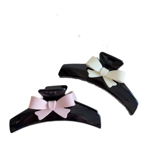 Elegant large hair claw clips set with pink and cream bows for stylish hair styling
