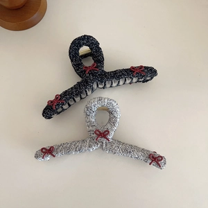 Elegant tweed hair claws in black and grey with red bows and gold metal springs