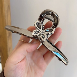 Pince à cheveux papillon argentée avec strass gris pour des coiffures de style français