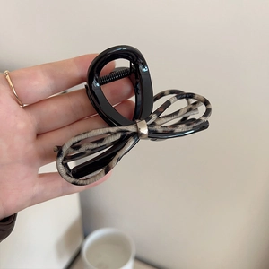 Brown leopard print bow claw clip made of sleek resin and fabric for women