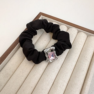 Elegant black scrunchie with silver metal base and pink rectangular gem decoration