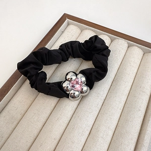 Black fabric scrunchie with silver floral metal charm and pink heart crystal centerpiece