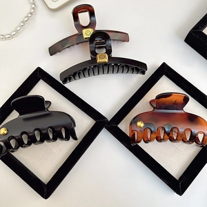 Elegant French vintage hair claws in black and tortoiseshell with gold accents