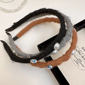 Detailed knit headbands with faux pearls and crystals in black, gray, and brown tones