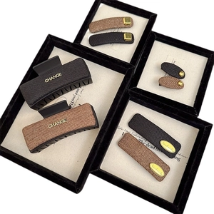 Elegant rectangular hair claw and side clip set with woven texture in black and brown