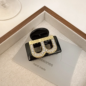 Pince à cheveux élégante en résine noire avec lettres GOOD LUCKY dorées et strass