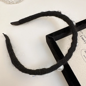 Elegant black knitted hairband with white pearls and sparkling rhinestones for women
