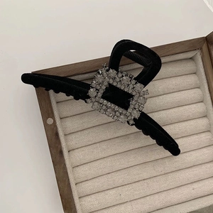 Detail of black velvet hair claw clip with large square rhinestone buckle decoration