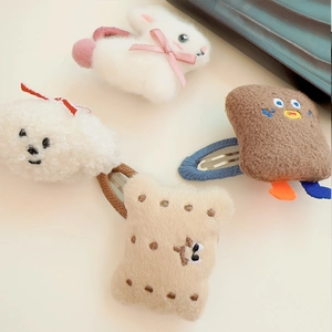 Close-up of cute plush hair clips featuring rabbit, dog, cookie and toast designs