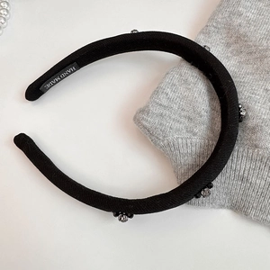 Handmade black sponge padded headband with crystals shown with pearls and sweater