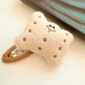 Close-up of plush bread cookie hair clip with embroidery and woven BB clip base