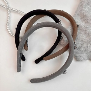 Detail view of handmade sponge padded headbands with crystal metal accents and knit texture