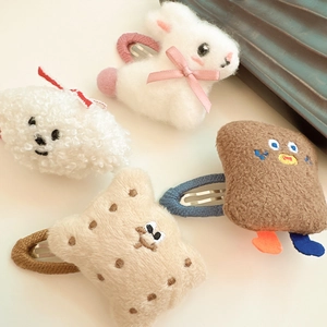 Detailed view of plush rabbit, puppy, toast and cookie hair clips with soft fur texture