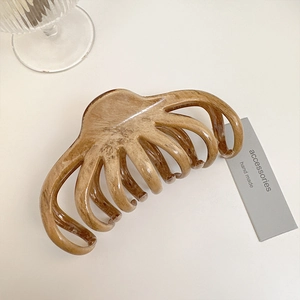 Vintage wood-toned amber marble hair claw clip for women in a minimalist floral shark style